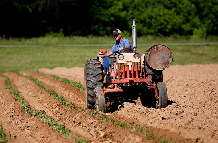 Man Riding Red Tractor On Field 2252618