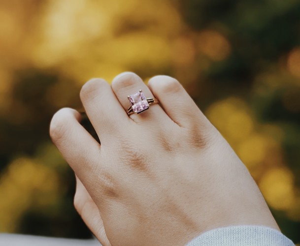 Person Wearing Silver Colored Ring With Pink Stone 2418478
